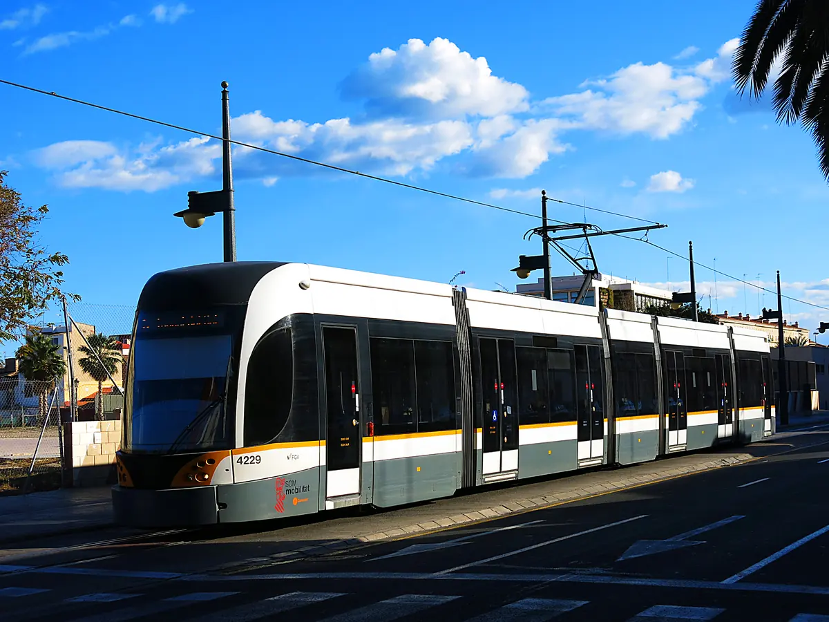 A Valencia tram on Carrer del Doctor Lluch in the Cabanyal under a blue sky