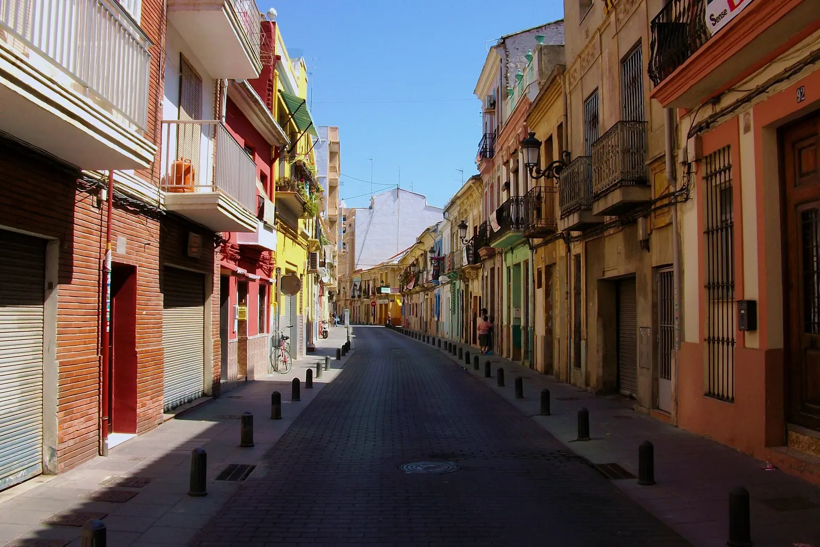 Carrer del Rosari in the Cabanyal, a narrow street of colourful old houses with their balconies in the afternoon light